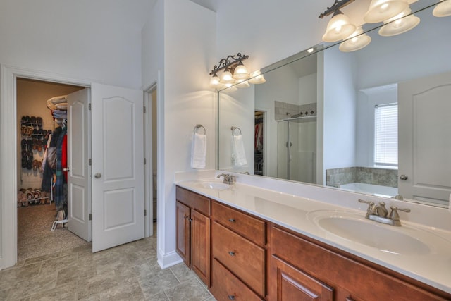 bathroom with vanity and shower with separate bathtub