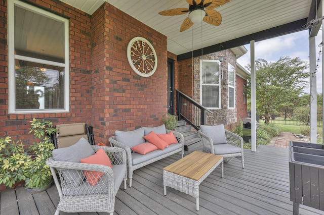 wooden deck featuring outdoor lounge area and ceiling fan