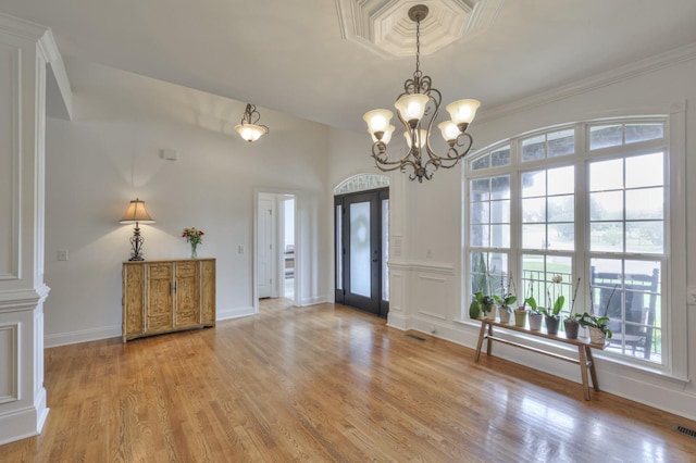 entryway with an inviting chandelier and light wood-type flooring