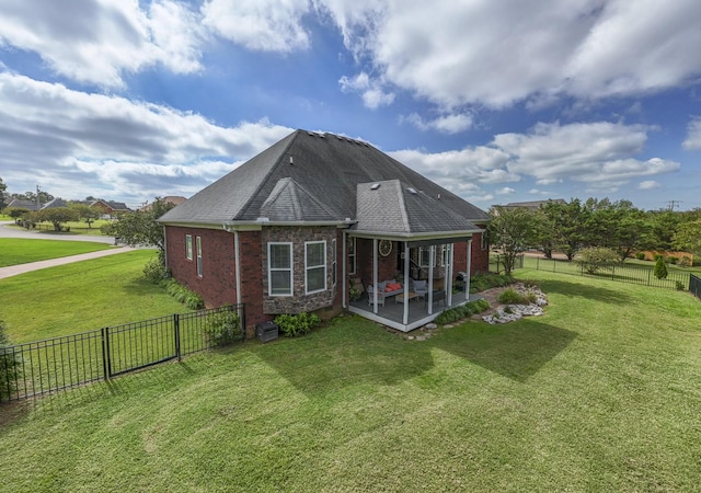 back of house featuring a lawn and a patio area