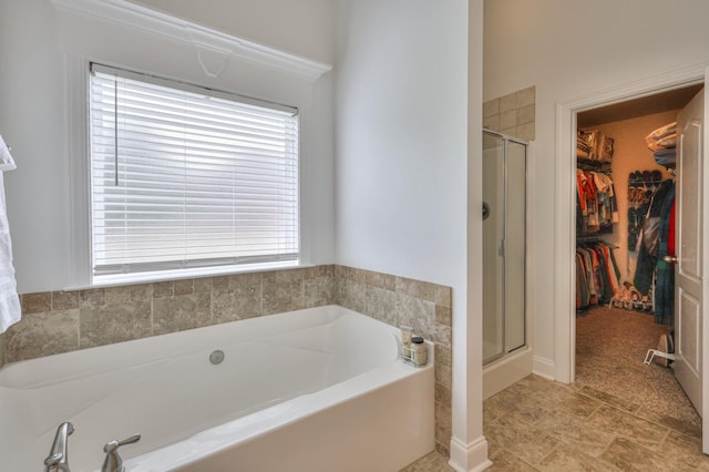 bathroom featuring independent shower and bath