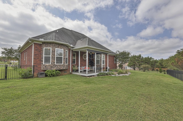 back of house with a lawn