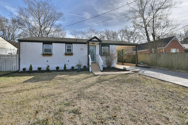 ranch-style home with a carport and a front lawn