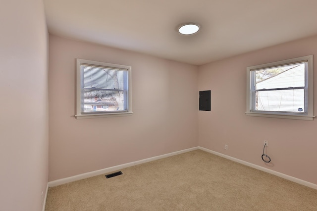 carpeted empty room with electric panel