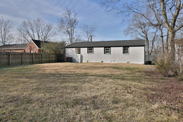 back of property featuring a lawn