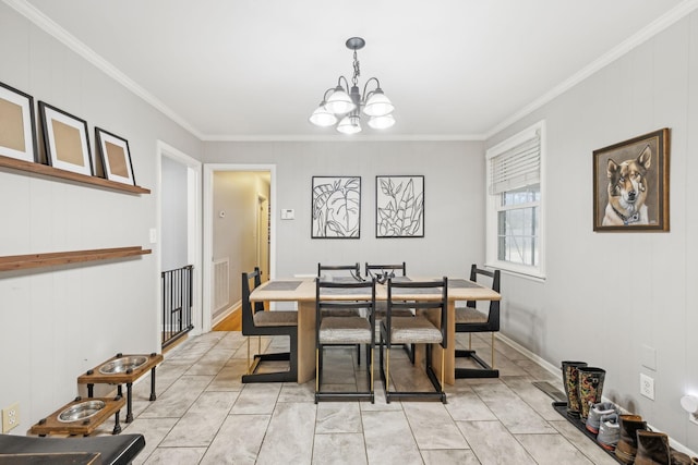 dining space featuring ornamental molding and a chandelier