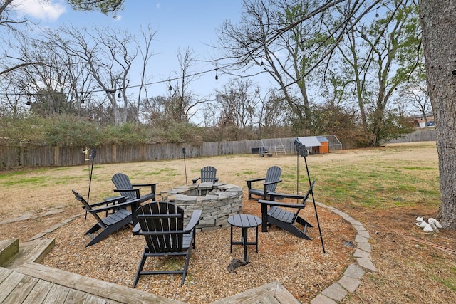 view of yard featuring an outdoor structure and a fire pit