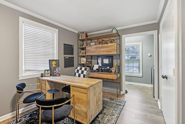 office area with ornamental molding and light hardwood / wood-style floors