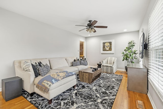 living room with hardwood / wood-style flooring and ceiling fan