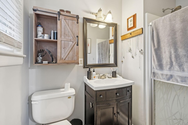 bathroom with vanity, a shower, and toilet