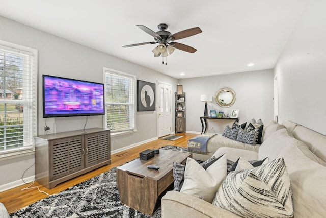 living room featuring ceiling fan and hardwood / wood-style floors