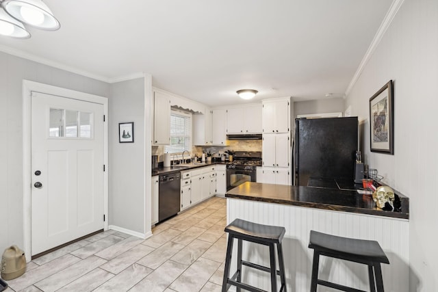 kitchen featuring white cabinetry, sink, kitchen peninsula, and black appliances