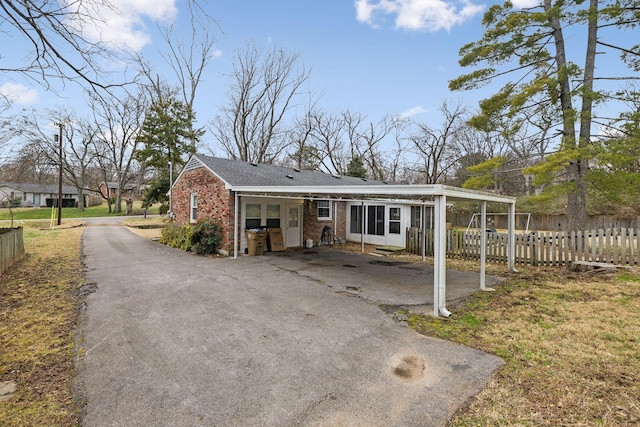 exterior space featuring a carport and a lawn