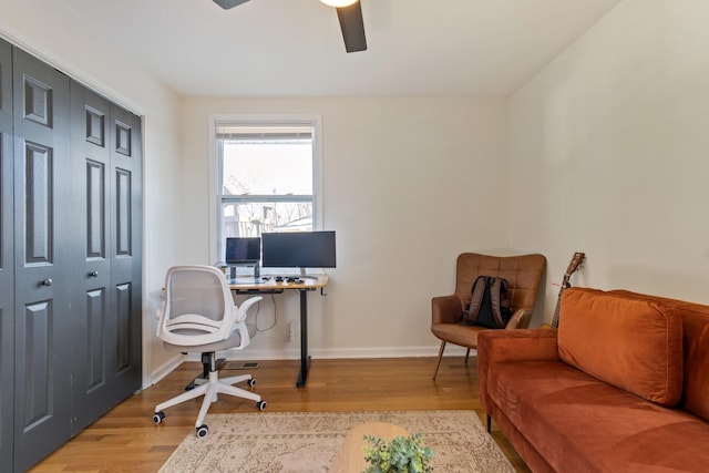 home office with ceiling fan and light hardwood / wood-style floors