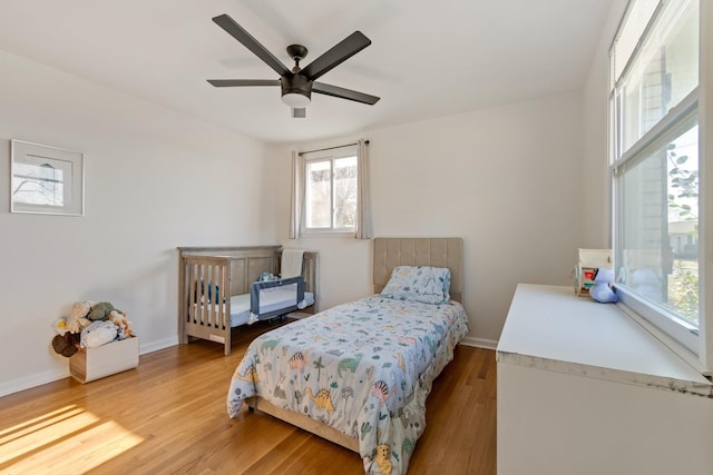 bedroom with ceiling fan and light hardwood / wood-style flooring