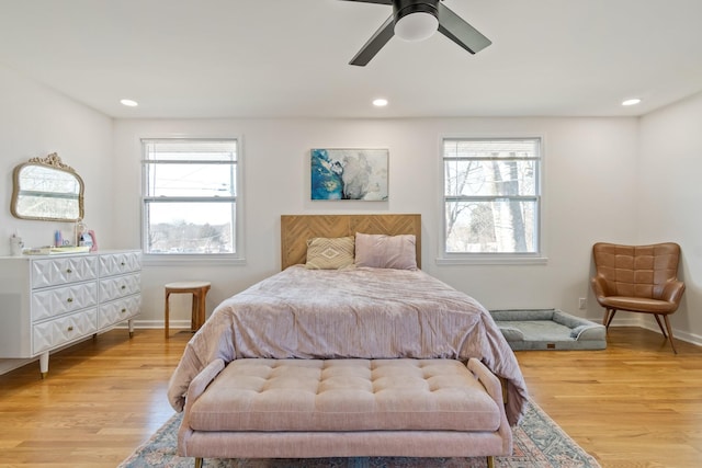 bedroom with light hardwood / wood-style flooring and ceiling fan