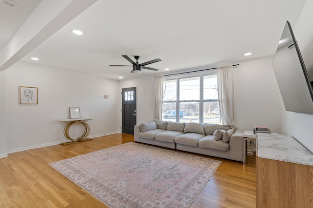 living room featuring ceiling fan and light wood-type flooring