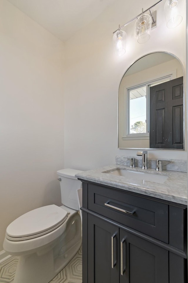 bathroom featuring vanity and toilet