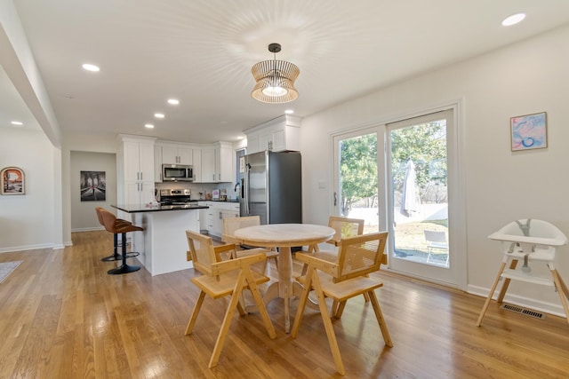 dining area with light hardwood / wood-style flooring