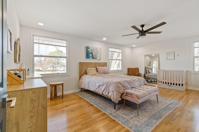 bedroom with ceiling fan and light hardwood / wood-style floors