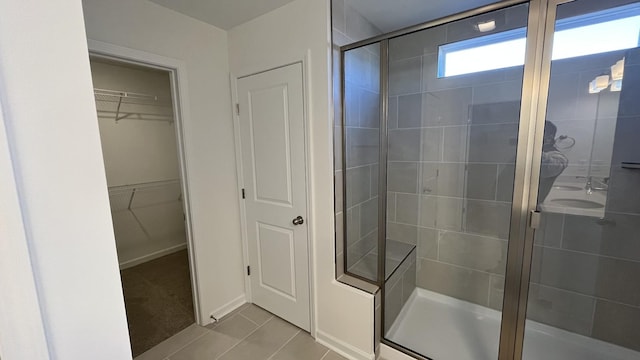 bathroom featuring an enclosed shower and tile patterned floors