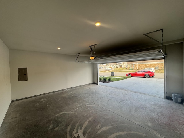 garage with a garage door opener and electric panel