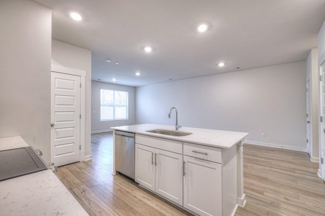 kitchen featuring sink, light hardwood / wood-style flooring, dishwasher, white cabinetry, and a center island with sink