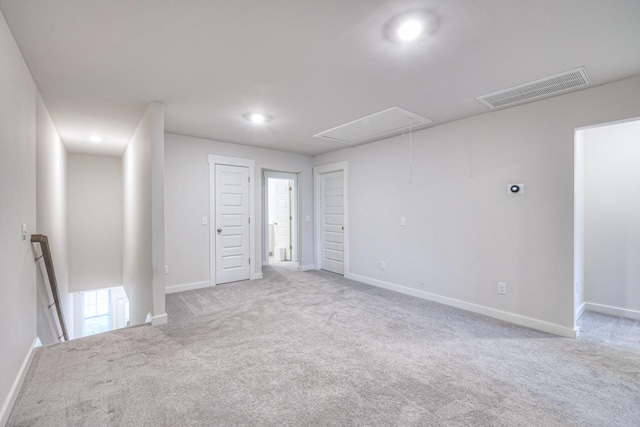 spare room featuring light colored carpet