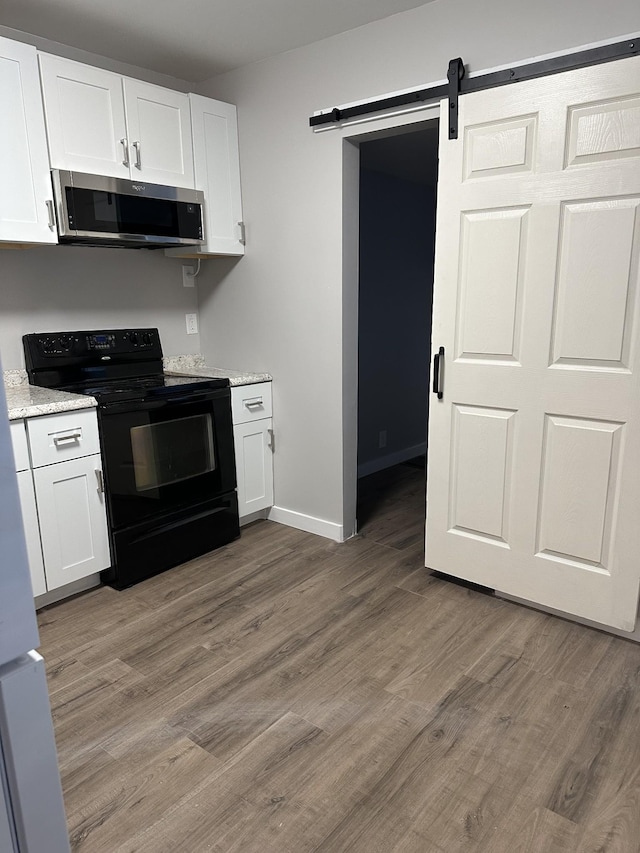 kitchen with white cabinets and black range with electric cooktop