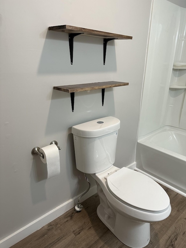 bathroom with walk in shower, hardwood / wood-style floors, and toilet