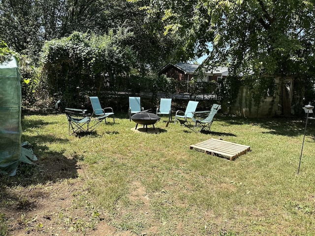 view of yard with an outdoor fire pit