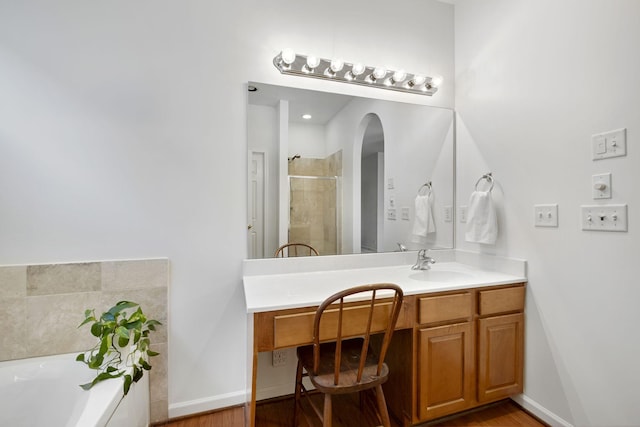 bathroom featuring vanity and shower with separate bathtub