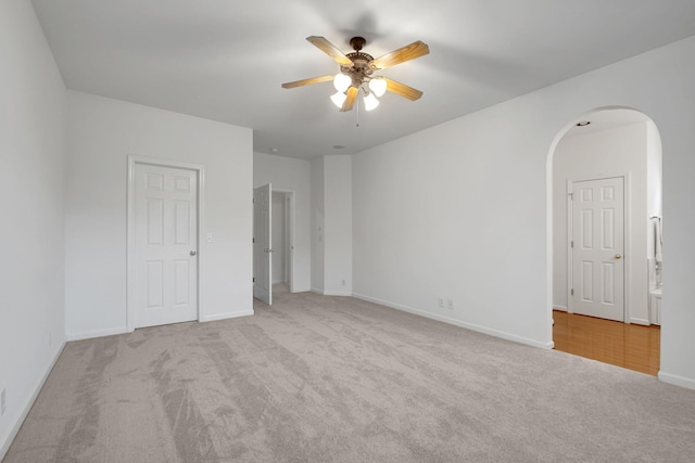 unfurnished room with ceiling fan and light carpet