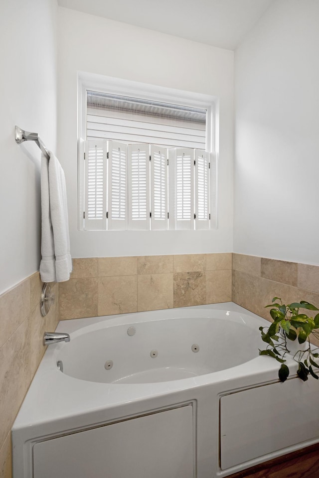 bathroom featuring a tub to relax in and a wealth of natural light