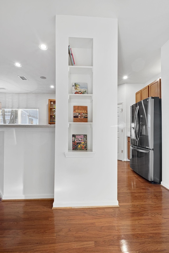 kitchen featuring dark hardwood / wood-style floors and stainless steel fridge with ice dispenser