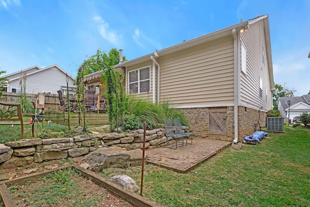 exterior space with a yard, central AC, and a patio