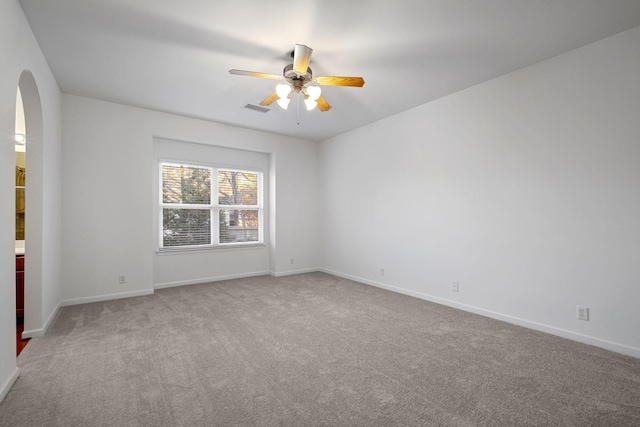 carpeted empty room featuring ceiling fan