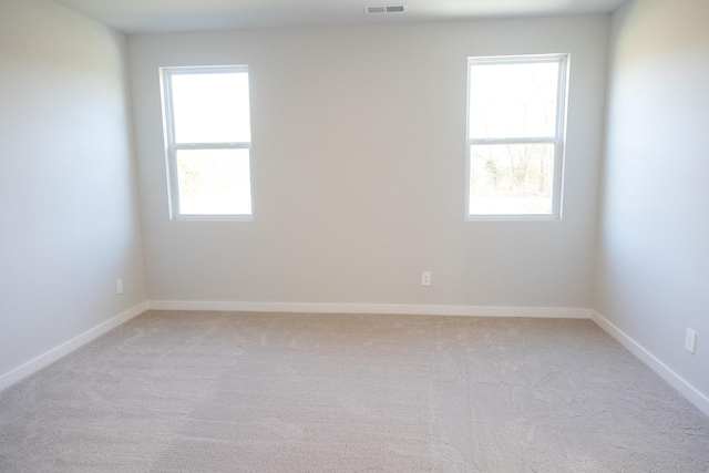 spare room with light colored carpet