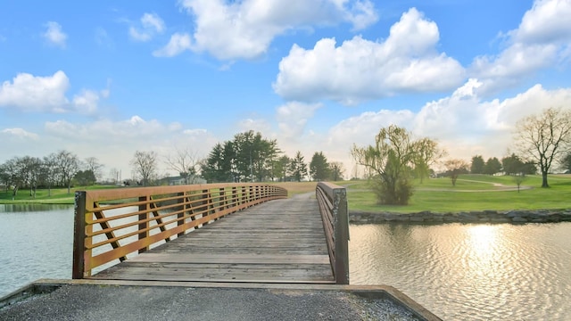 dock area featuring a water view and a lawn