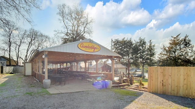 exterior space with an outdoor structure and a patio area