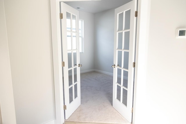 interior space with light colored carpet and french doors