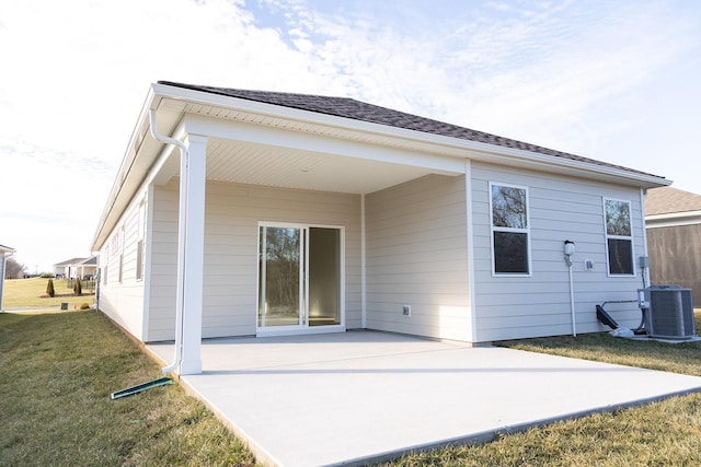 back of house with a yard, cooling unit, and a patio area