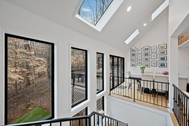 sunroom / solarium featuring vaulted ceiling with skylight