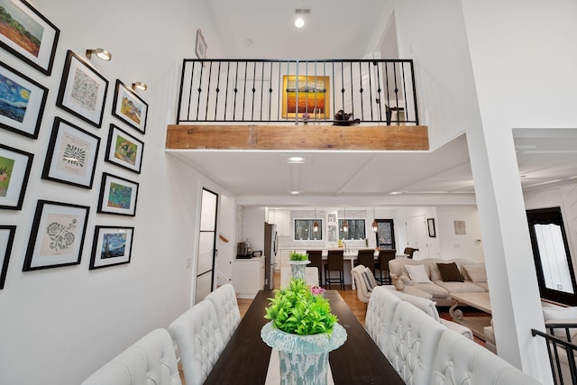 dining room with a towering ceiling