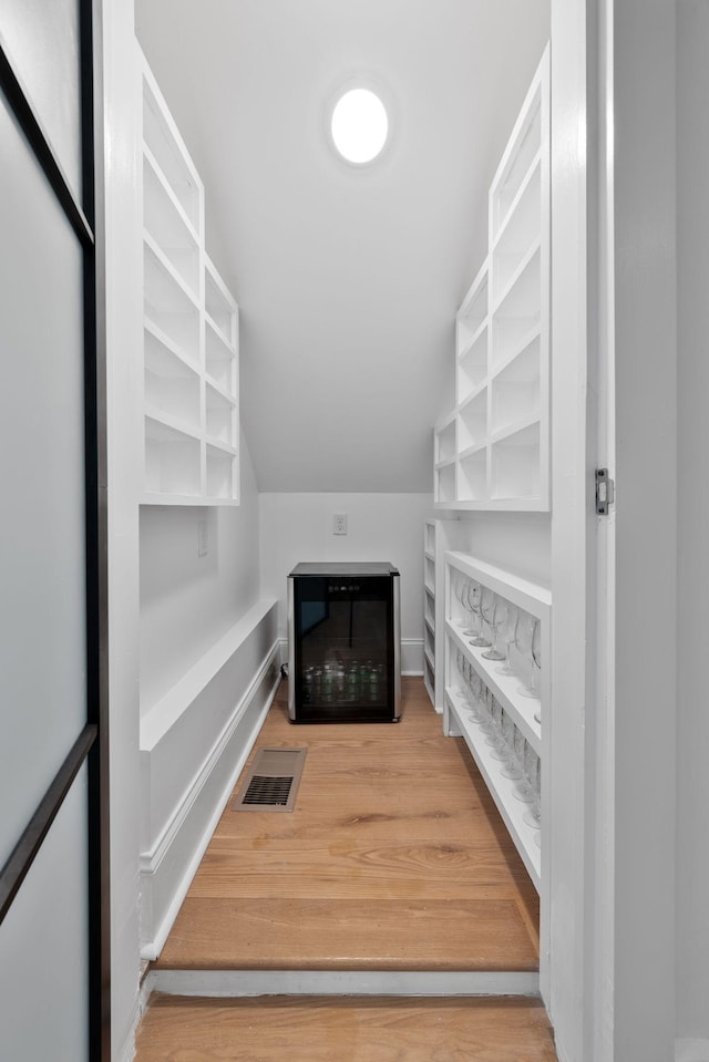 spacious closet featuring lofted ceiling and hardwood / wood-style flooring