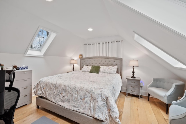 bedroom featuring lofted ceiling with skylight and light wood-type flooring