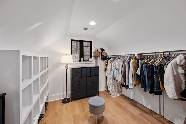 spacious closet with hardwood / wood-style floors and vaulted ceiling