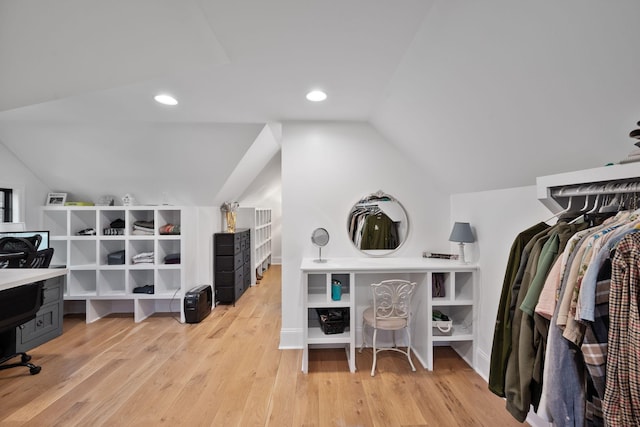 interior space with lofted ceiling and light hardwood / wood-style floors