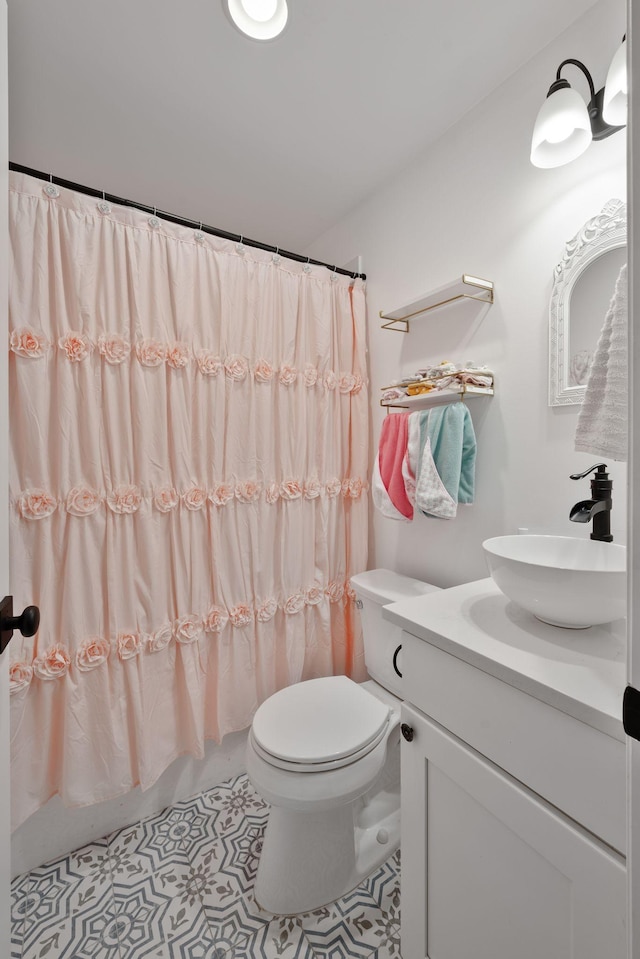 full bathroom featuring shower / tub combo, vanity, tile patterned floors, and toilet