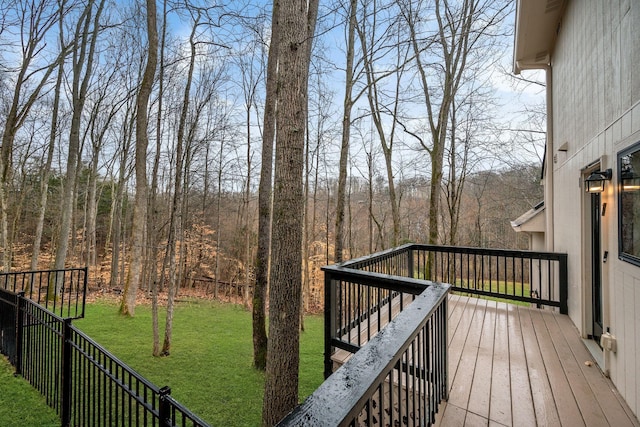 wooden terrace with a lawn